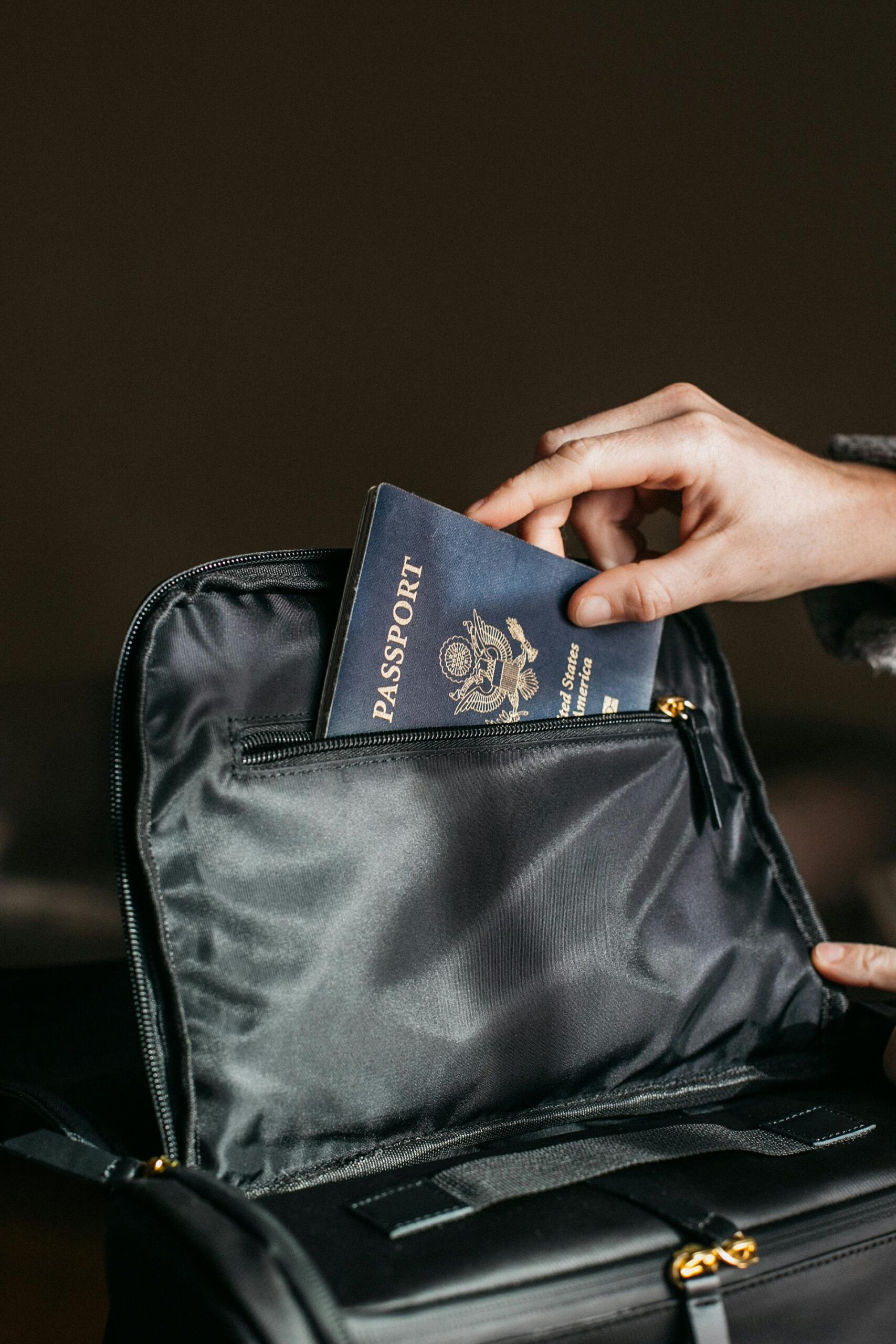 hand putting passport into bag after applying for a non-b visa for working in thailand